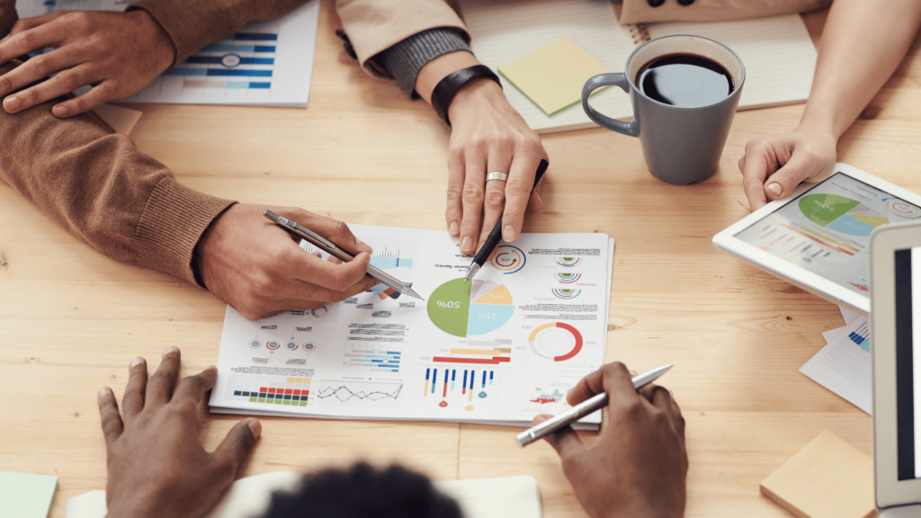 Customer service team studying current churn rates and other metrics from customer feedback