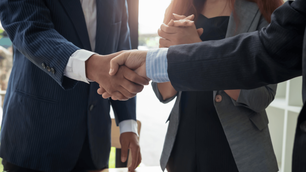 Business owner shaking hands with team leader at a remote staffing agency